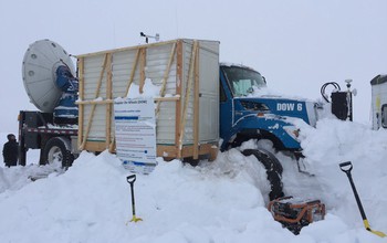 A Doppler-on-Wheels radar unit operates from a remote mountaintop location, requiring a lot of shoveling.